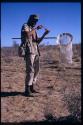 Wulf Haacke standing, holding a collecting net, looking in a jar
