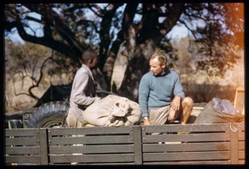 Kernel Ledimo and Foppe Hoogheimstra sitting in the back of an expedition truck