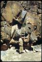Merl La Voy standing next to rocks with petroglyphs