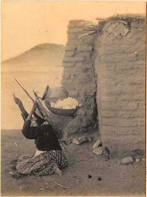 Woman carrying basket and pot in kiho