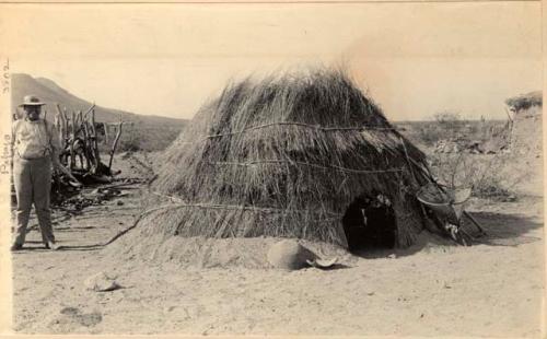 Man standing next to hut