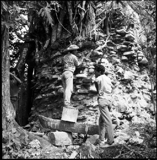 Mason working on wall of Structure 33 at Yaxchilan