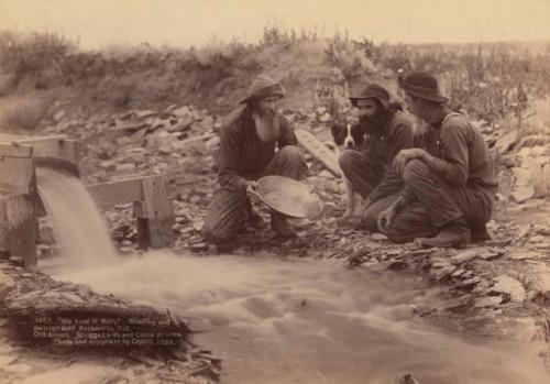 Prospectors washing and panning gold.