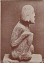 Carved stone human figure, side