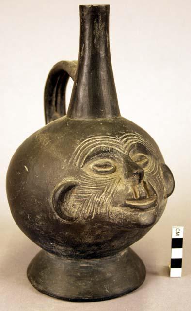 Ceramic bottle, stirrup spout, zoomorphic effigy, molded & incised face