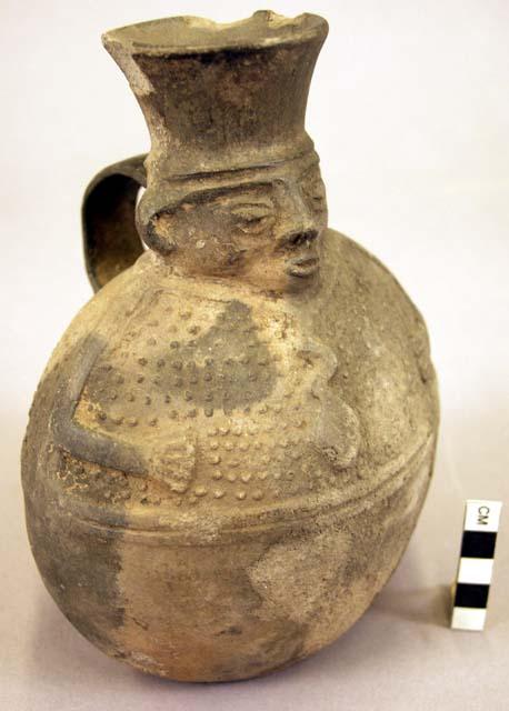 Pottery jar, handle on side, black, human form