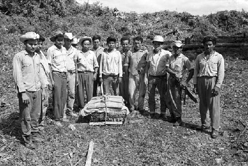 Men with crated fragment from Tamarindito