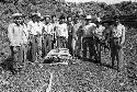 Men with crated fragment from Tamarindito