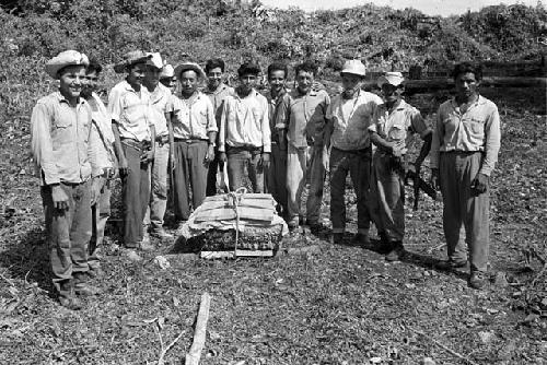 Men with crated fragment from Tamarindito