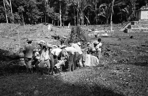 Carrying Stela 4.2 to helicopter at Seibal