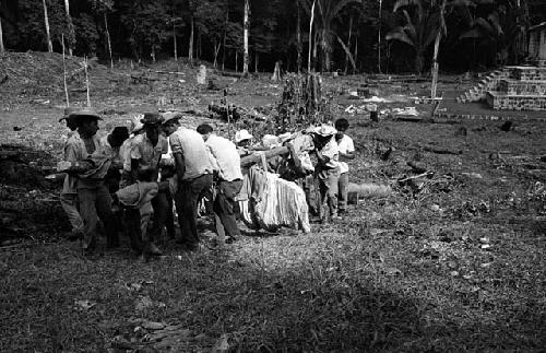 Carrying Stela 4.2 to helicopter at Seibal