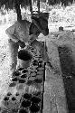 Lisandro Flores pouring panela into molds