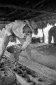 Lisandro Flores pouring panela into molds