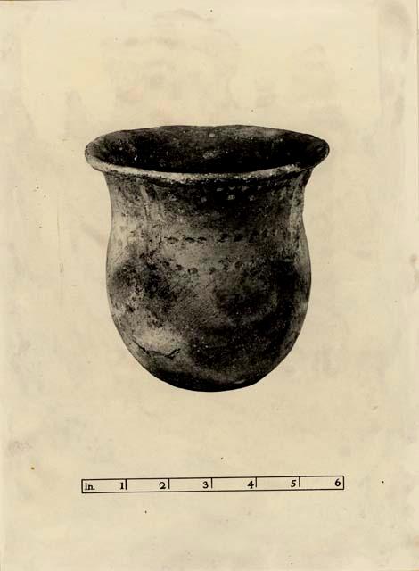 Small pot with suspension holes, carved with a variant of the sun symbol