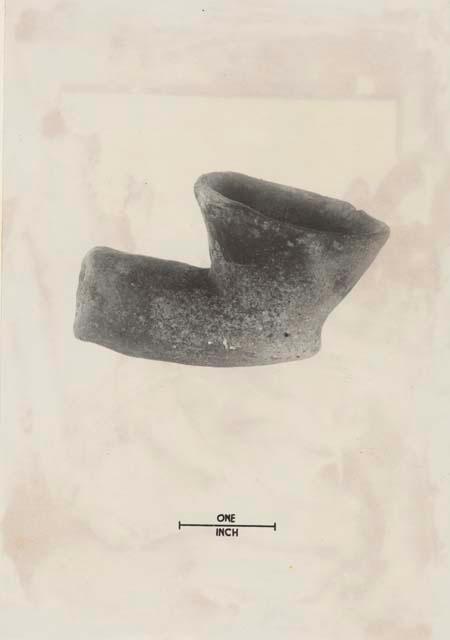 Earthenware pipe found on right shoulder accompanying burial 1-1 at depth of 19".