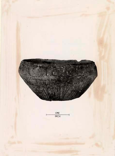 Bowl with inscribed linear design.