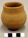 Ceramic miniature vessel, straight neck, round base, plain.