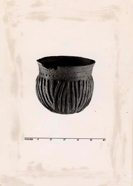 Pottery vessel with linear design.