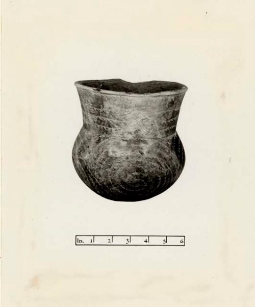 Jar with inscribed spiral design; lower portion of vessel bears four sets of int