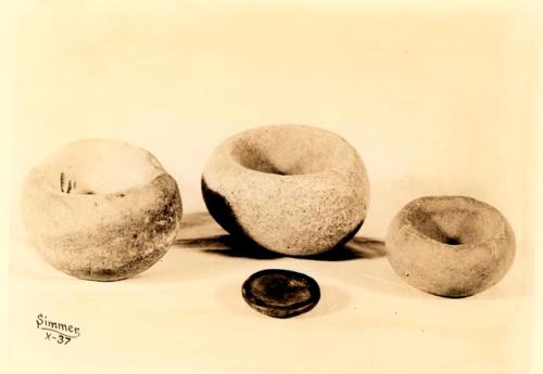 Stone bowls - resembles mortar. From old camp sites and graves of Salish