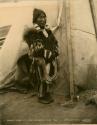 Inuit woman standing in front of tent