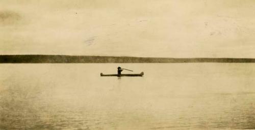 Cree person in a canoe