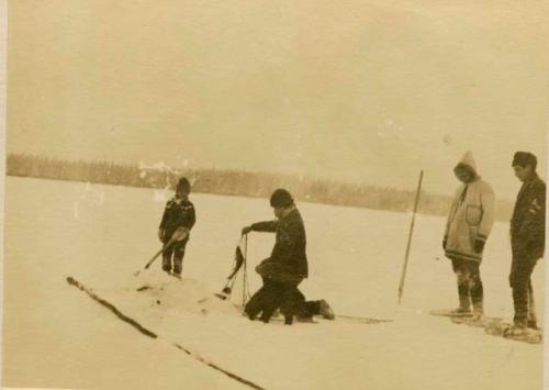 Montagnais man ice fishing