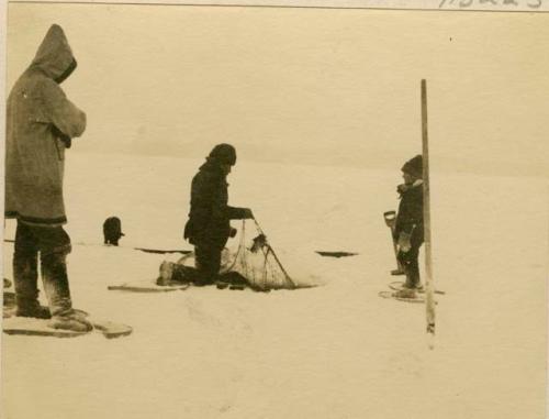 Montagnais man ice fishing