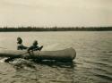 Two women paddling a canoe