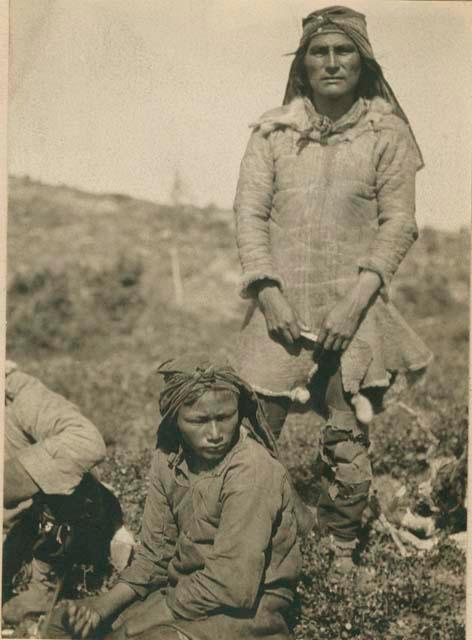 Naskapi man standing and a woman sitting