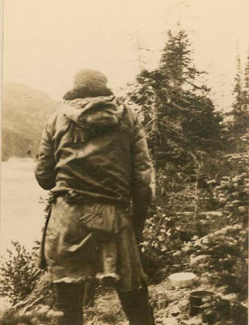 Naskapi man standing along Assinaban River