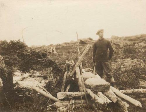 Man standing by low structure of poles