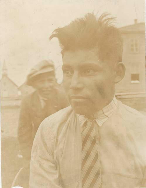 Naskapi man in Western clothes. Boy in background.