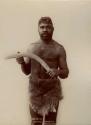 Studio portrait of Aboriginal man holding a boomerang