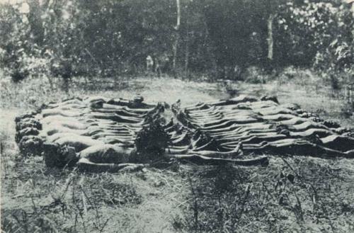 Male youths lying on ground as part of Initiation Ceremony