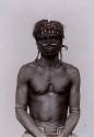 Studio portrait of an Aboriginal Man of Queensland wearing a Headdress and a Bone through his Septum