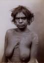 Studio portrait of an Aboriginal woman with ritual scarification on her upper body