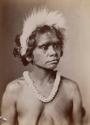 Studio Portrait of Young Aboriginal Woman wearing Necklace and Fur Headress