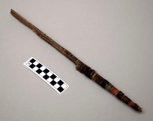 Worked stick wrapped with sinew