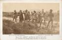 Eleven Aboriginal men and women standing, some men carry spears and stand in fighting poses