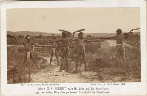 Six Aboriginal men standing outdoors in fighting poses