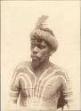 Aboriginal Man photographed wearing white ochre body paint and showing ritual scarification