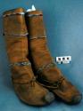 Pair of boots. Soles are well worn rawhide w/ disc shaped toe. Buckskin uppers
