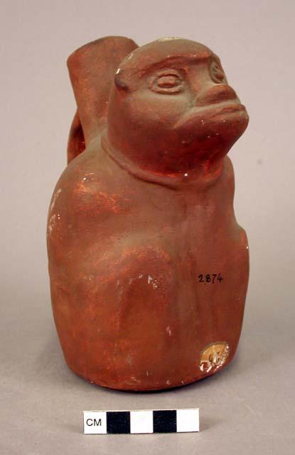 Ceramic bottle, strap handle, animal effigy, molded head, engraved legs