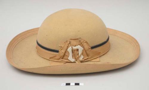 Cochabamba hat; tan wool felt with tan and black ribbon, tasseled cord; white, probably plastic, buckle