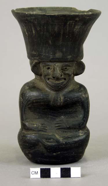 Pottery vessel in form of squatting human figure