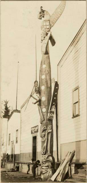 Totem pole in village setting