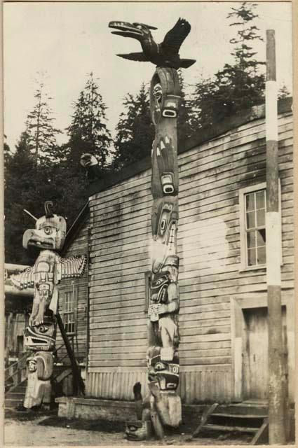 Totem poles in village setting