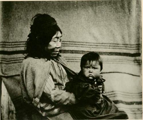 Quatsino woman holding her grandchild