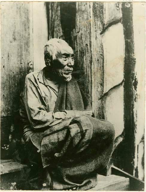 Grandfather sitting on doorsteps